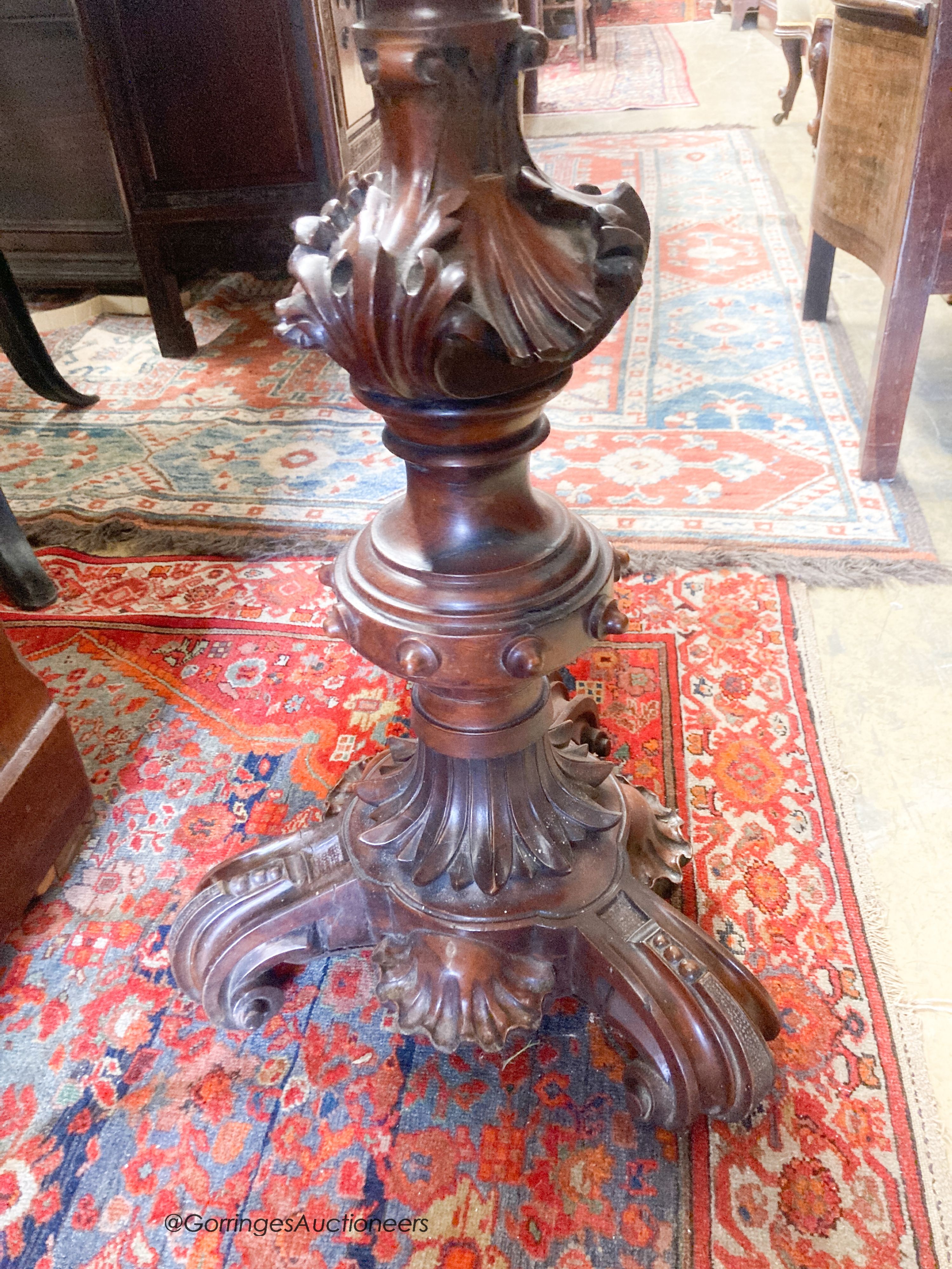 A late Victorian carved mahogany torchere, height 120cm